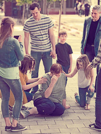 People of different ages helping grandmother  with pain in heartの写真素材