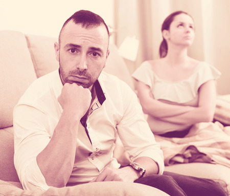 Sad male is depressing and husband is supporting him at home.の写真素材