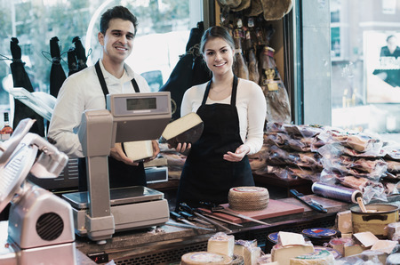 Portrait of armenian sellers offering cheese and wurst in shopの写真素材
