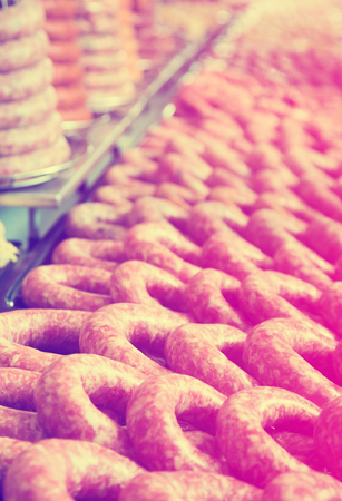 Raw sausage on counter in supermarket, close upの写真素材