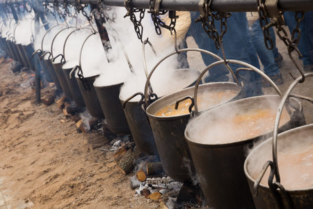 Bowlers with food on bonfire, cooking  outdoor in a traditional style, Spain