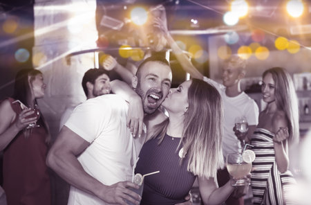 couple of  happy people together in the night club with drinks