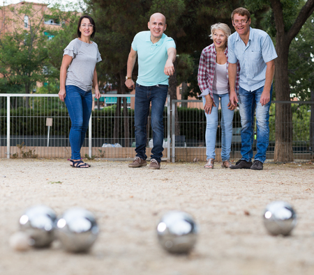 Portrait of friendly mature couples playing petanque at leisureの写真素材