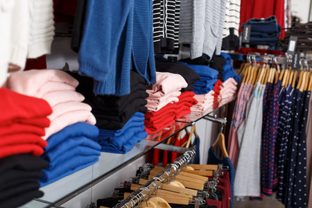 Close up view of stand with various clothes in clothing shop
