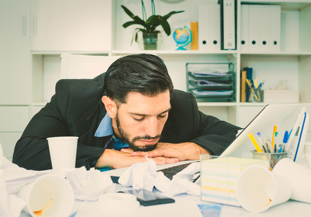 Businessman is resting after productive work day in office.の写真素材