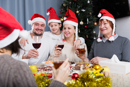 Big happy family celebrating Christmas, enjoying dinner at homeの写真素材