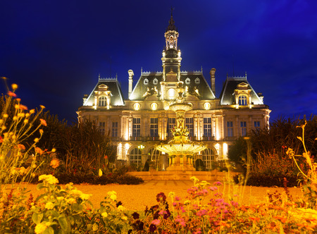 Night view of lighted main facade of Limoges Town Hall, Franceの写真素材