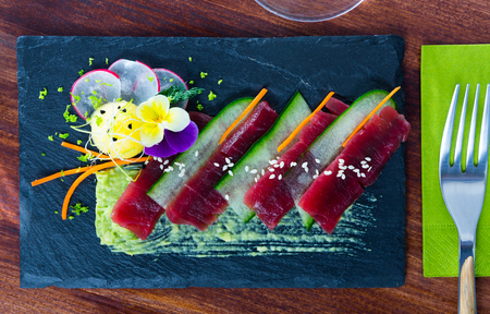Japanese dish â sashimi with fresh tuna, mango and zucchini served on slateの写真素材