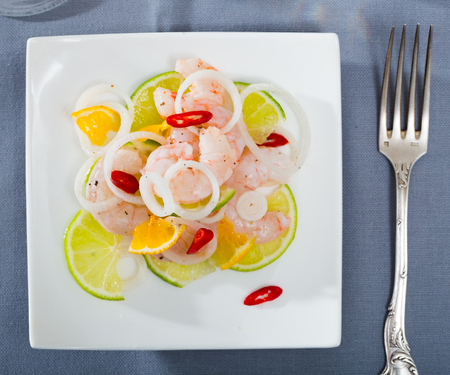Seafood ceviche with shrimps, tangerine, lime and onion ringsの写真素材