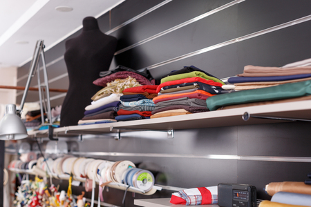 Close up view of pieces of cloth and tailor mannequin at sewing atelierの写真素材