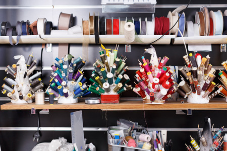 Close up view of colorful spools of thread and laces at sewing atelierの写真素材