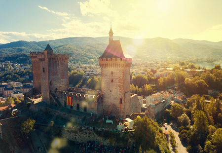 Aerial view of impressive medieval castle on rocky outcrop in French commune of Foixの写真素材