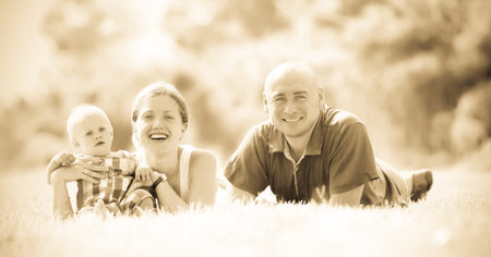 Happy family of three in grass