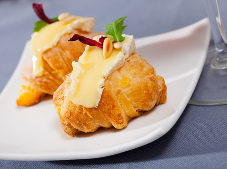 Image of camembert cheese on a mini croissant, french dessert at plateの写真素材