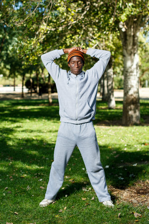 Athletic male man standing and spread his hands to the sides before training exercises