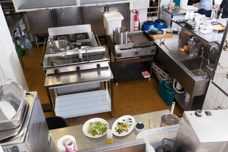 View of worktops and kitchen equipment in empty professional restaurant kitchenの写真素材