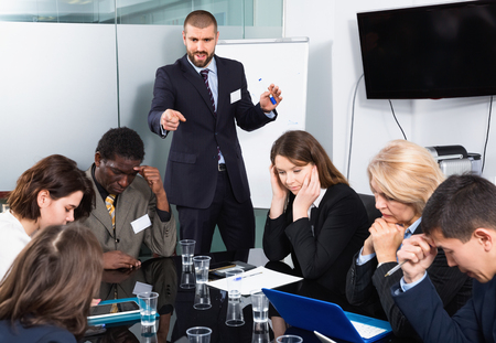 Irritated unhappy businessman expressing dissatisfaction with teamwork of colleagues at meetingの写真素材