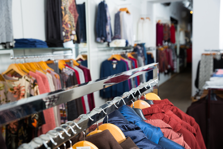 Close up view of stand with various coats in clothing boutiqueの写真素材