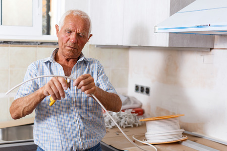 Capable elderly man working on his home renovationsの写真素材