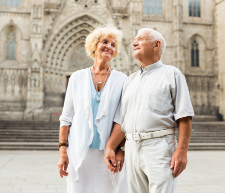 Happy loving spouses enjoying walk around European cityの写真素材