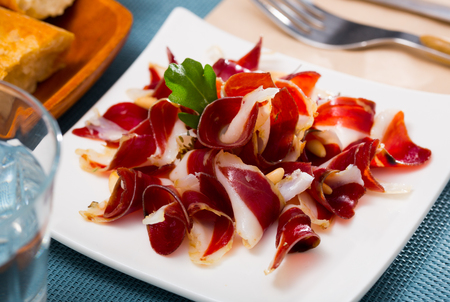 Delicious appetizer dried duck breast magret with pine nutsの写真素材