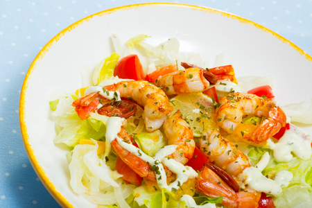 Salad with fried tiger shrimps, chorizo sausages and fresh cabbage, pepper, tomatoesの写真素材