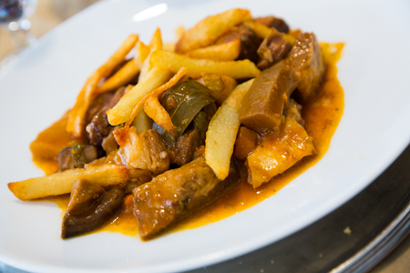 Tasty stewed beef with mushrooms and potatoes served on white plateの写真素材