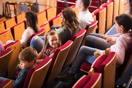 Child is distracted from screen during movie in cinemaの写真素材