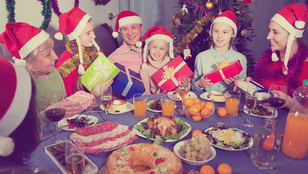 Portrait of happy family who is satisfied of presents in time celebration New Year at homeの写真素材
