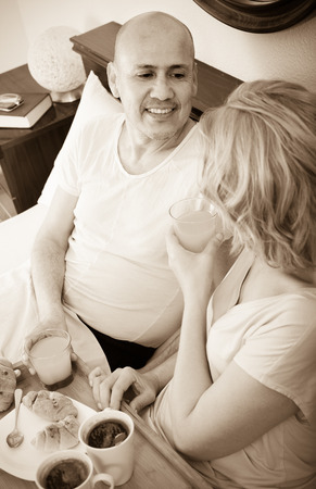 Mature family posing with coffee and pastryの写真素材