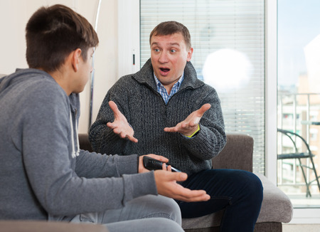 Dissatisfied father scolds young sonの写真素材
