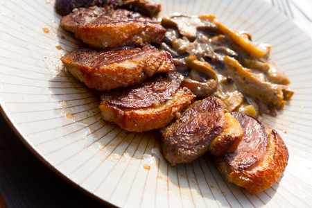 Slices of duck magret with mushroomsの写真素材