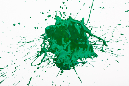 Artistic image of green paint spot spilled on background of white paper, nobodyの写真素材
