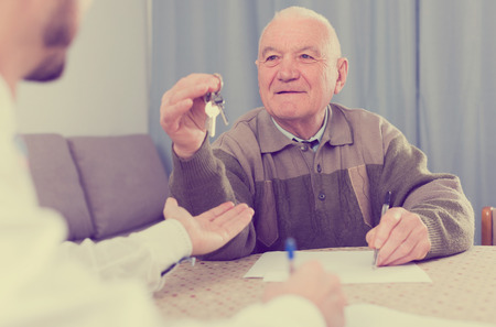Mature man preparing property papers for sale at homeの写真素材