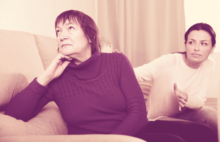 Portrait upset adult women looking away after conflict at home interiorの写真素材