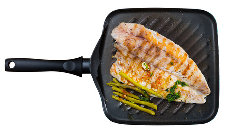 Delicious grilled bass with asparagus. Isolated over white backgroundの写真素材