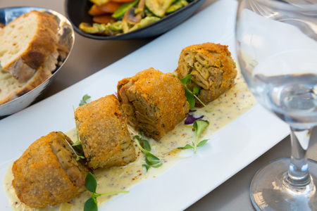 Piquant breaded Andouillette - traditional French sausage made with pork intestines or chitterlings and seasoningsの写真素材