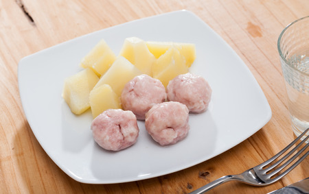 Steamed turkey meatballs with vegetable garnish of cooked potatoes. Diet and health conceptの写真素材