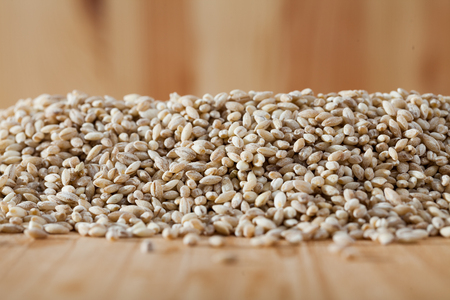 Pearl barley on a wooden surface, macroの写真素材