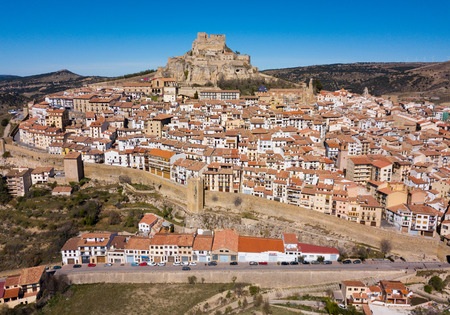 Aerial view of Morella cityscape with ancient fortified castle on top of rock in sunny day, Spainのeditorial素材