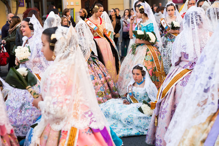 VALENCIA, SPAIN - MARCH 18, 2019: People in Spanish national costumes walking through streets of Valencia during Fallesのeditorial素材