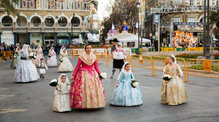 VALENCIA, SPAIN - MARCH 18, 2019: Holiday procession in national dressed during Falles (Fallas)...