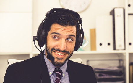 Portrait of spanish man dispatcher who is talking with client in office.の写真素材
