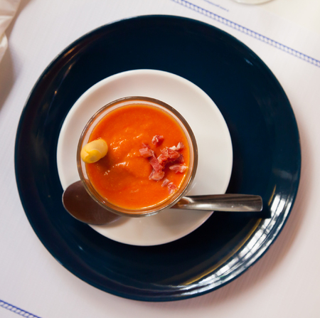 Traditional Spanish cuisine, Salmorejo with ham served in glass bowlの写真素材