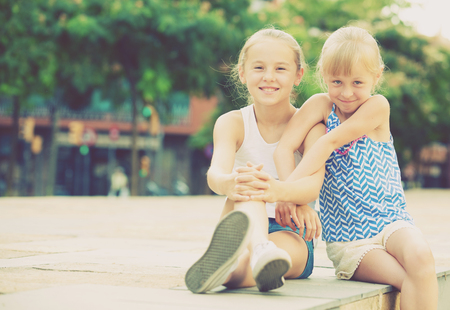 Portrait of two girls playmates outdoors in summer dayの写真素材