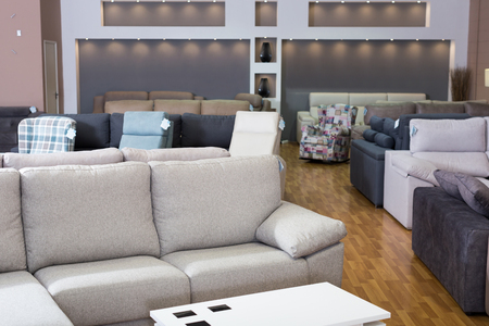 Interior of furniture salon shopping room with sofas