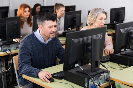 Portrait of focused mature man during computer classes at university of third ageの写真素材
