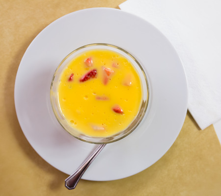 Top view of popular Spanish custard dessert with berries of ripe sweet strawberry in glass bowlの写真素材