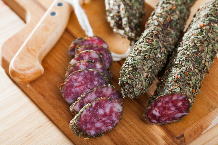 Sliced spanish sausage fuet with herbsの写真素材