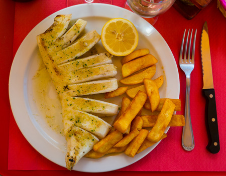 Fried squid served with baked potatoesの写真素材